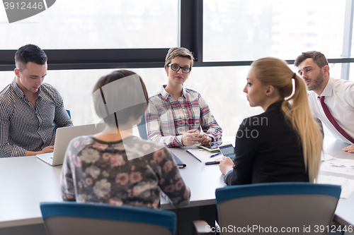Image of young business people group on meeting at modern office
