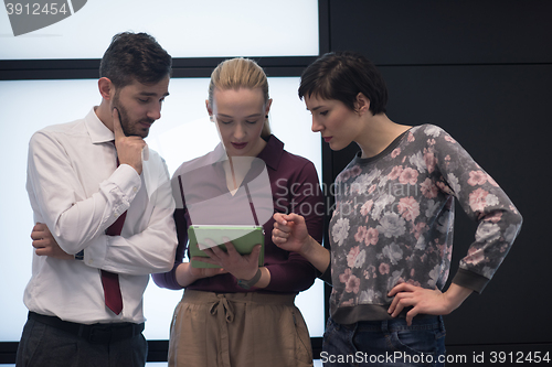 Image of young business people group working on tablet