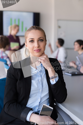 Image of portrait of young business woman at office with team on meeting 