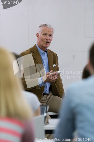 Image of teacher with a group of students in classroom