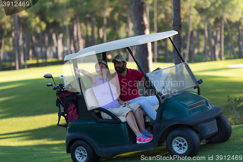 Image of couple in buggy on golf course