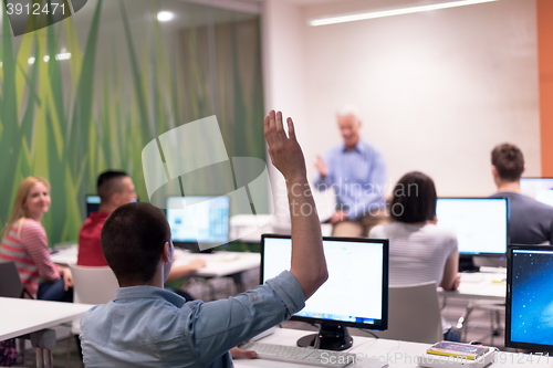 Image of student answering a question in classroom