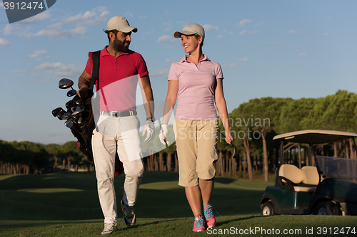 Image of couple walking on golf course