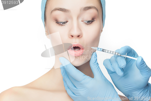 Image of Attractive woman at plastic surgery with syringe in her face