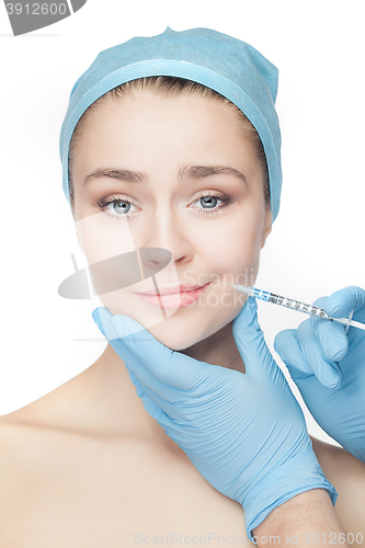 Image of Attractive woman at plastic surgery with syringe in her face