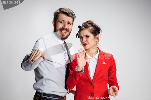 Image of The business man and woman communicating on a gray background