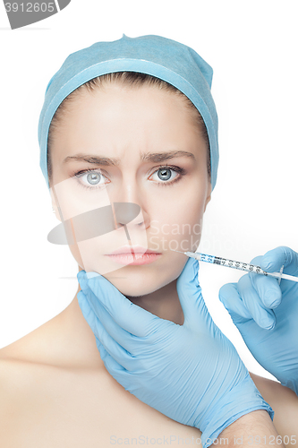 Image of Attractive woman at plastic surgery with syringe in her face