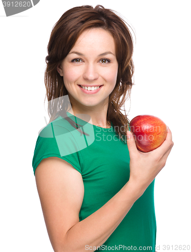 Image of Young happy girl with apple