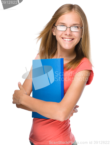 Image of Young student girl is holding book