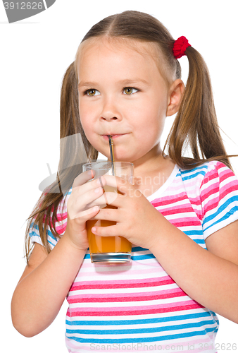 Image of Little girl is drinking carrot juice