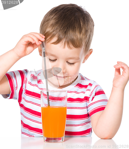 Image of Little boy with glass of carrot juice