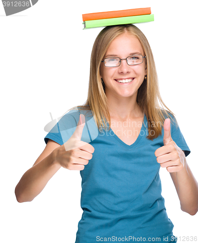 Image of Young student girl is showing thumb up gesture