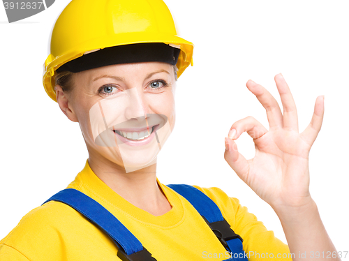 Image of Young construction worker is showing OK sign