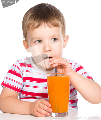 Image of Little boy with glass of carrot juice