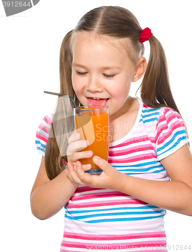 Image of Little girl is drinking carrot juice