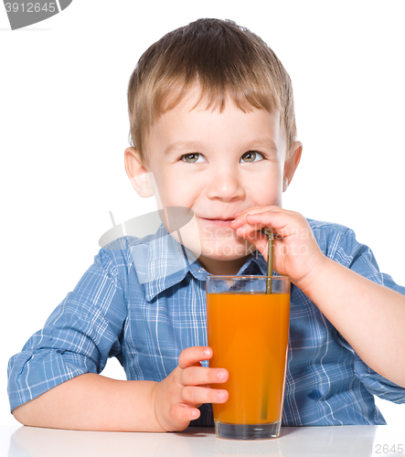 Image of Little boy with glass of carrot juice