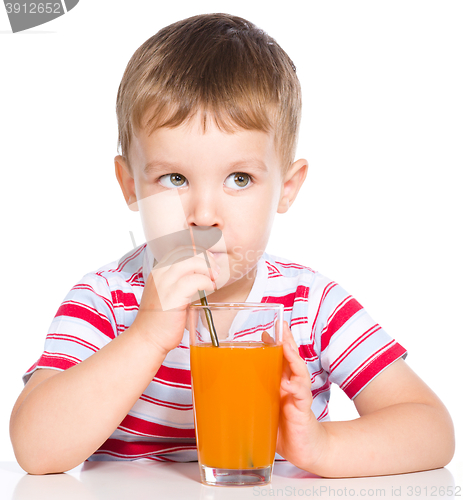 Image of Little boy with glass of carrot juice