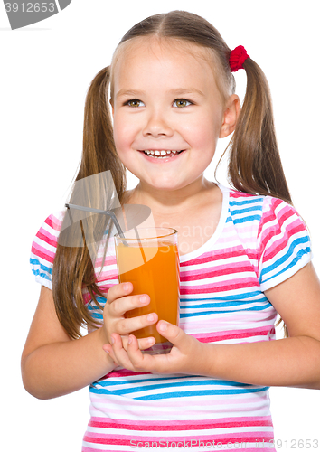 Image of Little girl is drinking carrot juice