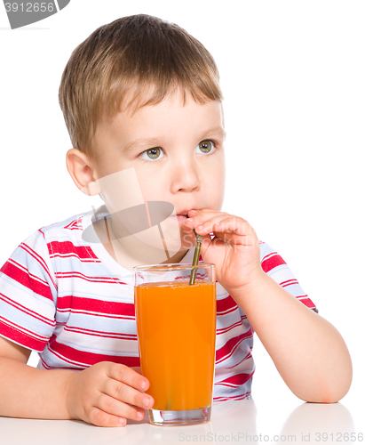 Image of Little boy with glass of carrot juice