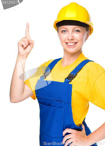 Image of Young construction worker pointing up