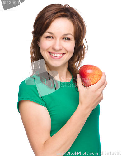 Image of Young happy girl with apple