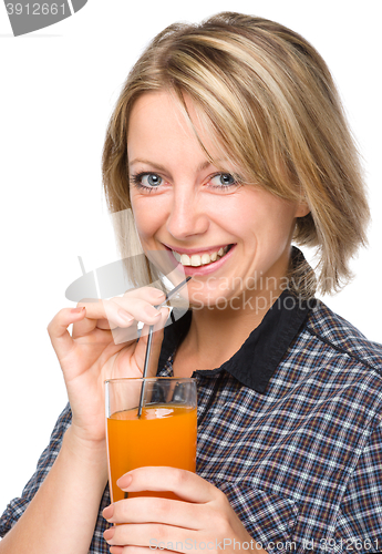 Image of Young woman is drinking carrot juice