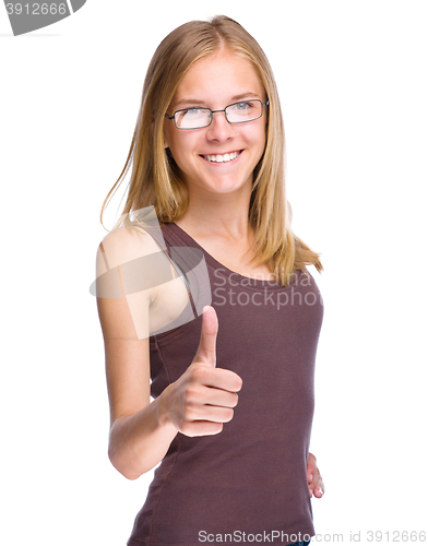 Image of Young teen girl is showing thumb up gesture