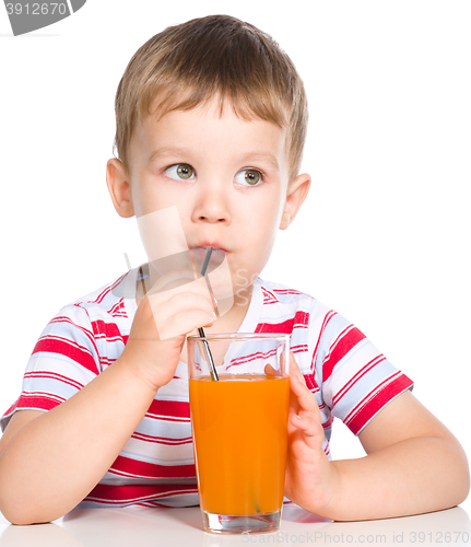 Image of Little boy with glass of carrot juice