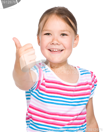 Image of Little girl is showing thumb up gesture