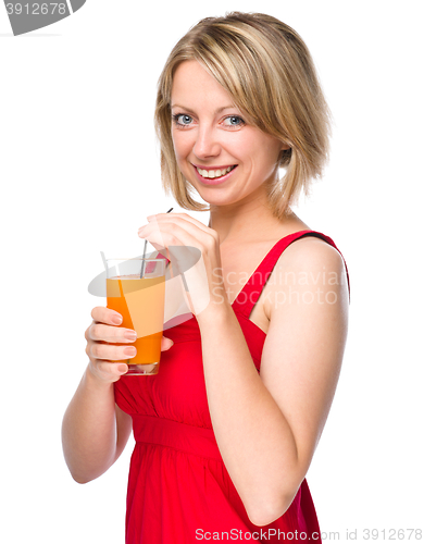 Image of Young woman is drinking carrot juice