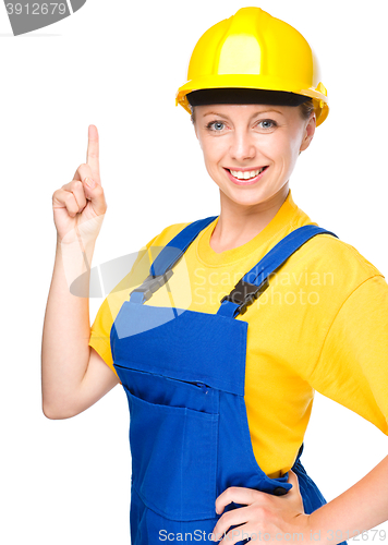 Image of Young construction worker pointing up