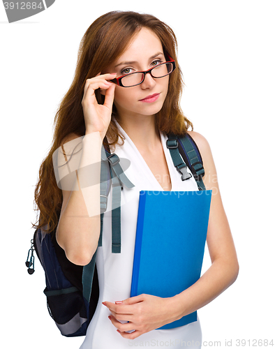 Image of Young student girl is holding book