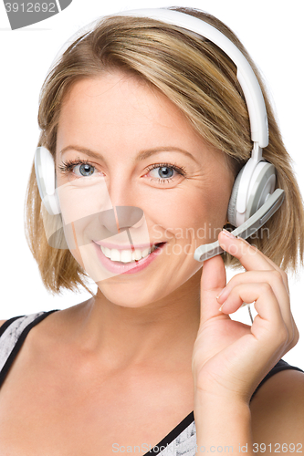 Image of Lovely young woman is talking to customers