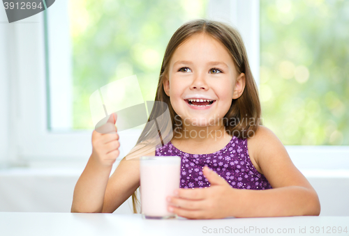 Image of Cute little girl with a glass of milk