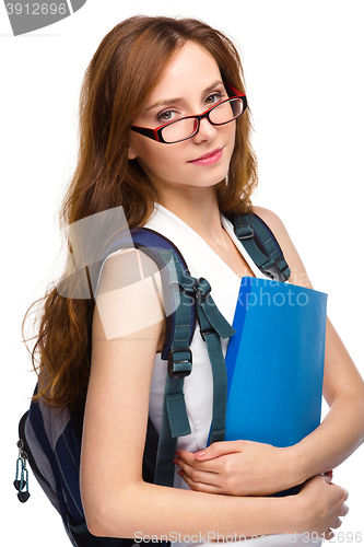 Image of Young student girl is holding book