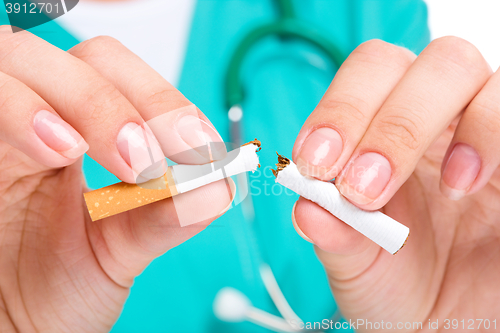 Image of Doctor in uniform breaks cigarette