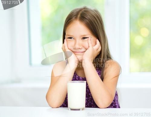 Image of Cute little girl with a glass of milk