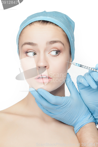 Image of Attractive woman at plastic surgery with syringe in her face