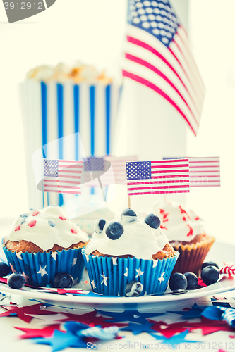 Image of cupcakes with american flags on independence day