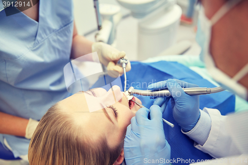 Image of close up of dentist treating female patient teeth