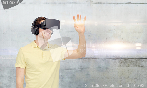 Image of happy man in virtual reality headset or 3d glasses