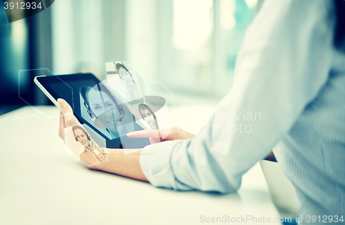 Image of close up of woman hands with tablet pc at office