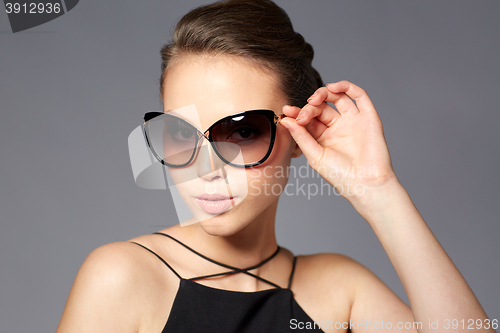 Image of beautiful young woman in elegant black sunglasses