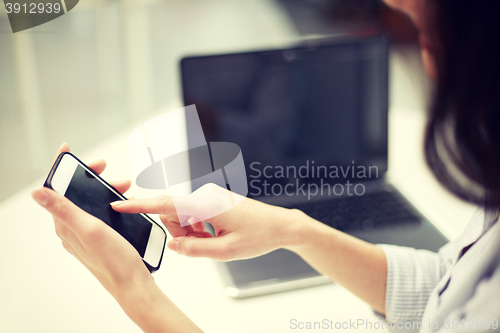 Image of close up of woman texting on smartphone at office