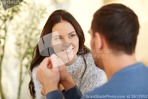 Image of happy couple holding hands at restaurant or cafe