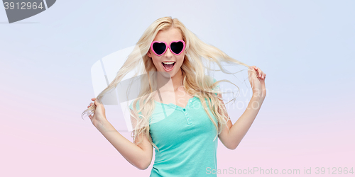 Image of happy young blonde woman or teenager in sunglasses