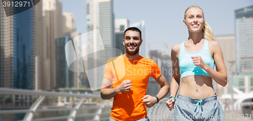 Image of couple running over dubai city street background