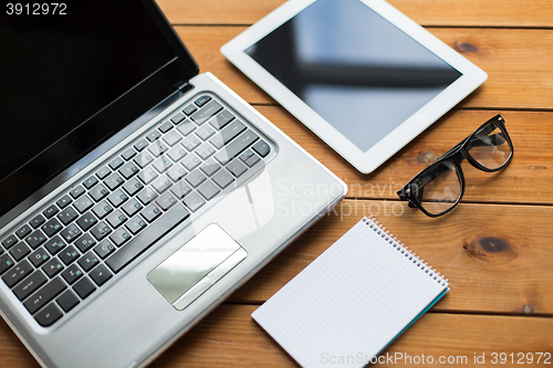 Image of close up of on laptop, tablet pc and notebook