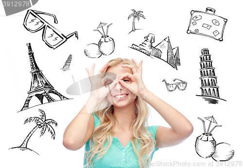 Image of young woman looking through finger glasses