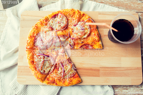 Image of close up of pizza with coca cola on table